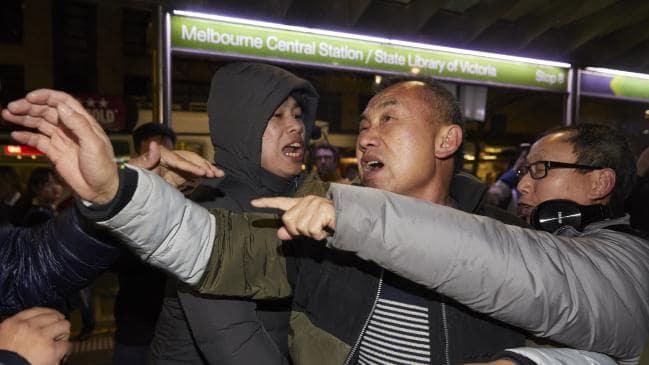 Hong Kong democracy demonstrators try to calm a fellow demonstrator. Picture: AAP Image/Erik Anderson