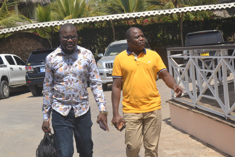 Tanariver director of communication Steve Juma with governor Dhadho Godhana arrive for the press conference at ocean beach resort and spa in Malindi .