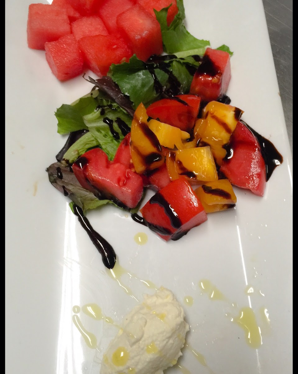 House made ricotta with local tomatoes and watermelon with a balsamic reduction and lime infused oil