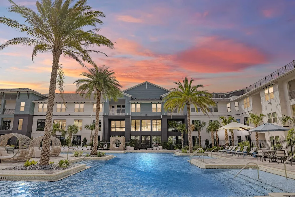 Forena Luxury Living's resort-style swimming pool with cabanas and palm trees