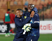 Mamelodi Sundowns players Andile Jali and goalkeeper Kennedy Mweene celebrate after beating Al Ahly 1-0 in their Caf Champions League Group A match at Cairo International Stadium on February 26 2022.