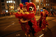 Lion Dancers perform along Market street as the annual parade for the Lunar New Year returns to the famed Chinatown neighborhood after a hiatus last year due to the Covid-19 pandemic, in San Francisco, California, US, on February 19 2022.  