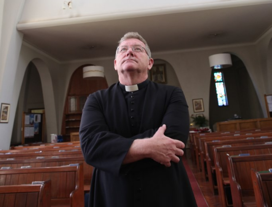 Father Dane Elsworth looks up at the damage caused to the St Cyprian’s Anglican Church in Umbilo, Durban, on November 8 2019.