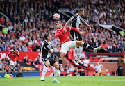 Cristiano Ronaldo of Manchester United jumps for a header with Jamaal Lascelles of Newcastle United during the Premier League match  at Old Trafford on September 11 2021 in Manchester, England. 