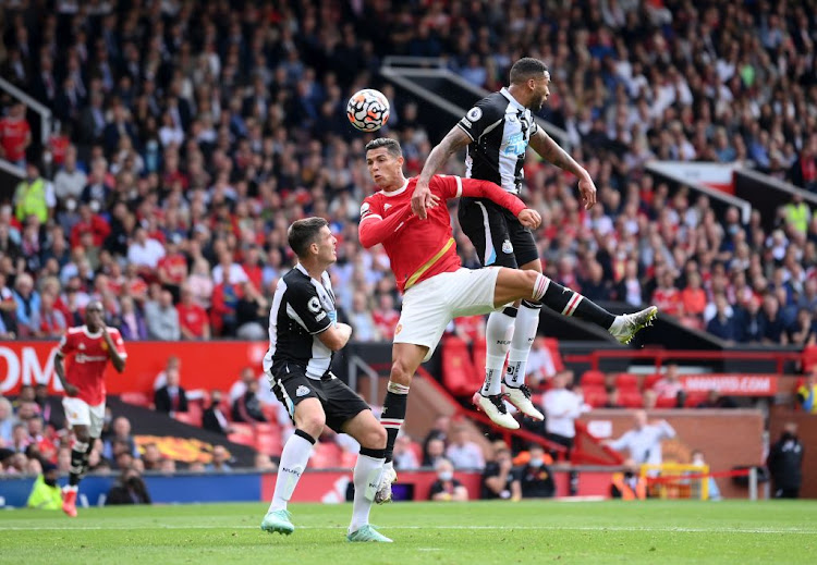 Cristiano Ronaldo of Manchester United jumps for a header with Jamaal Lascelles of Newcastle United during the Premier League match at Old Trafford on September 11 2021 in Manchester, England.