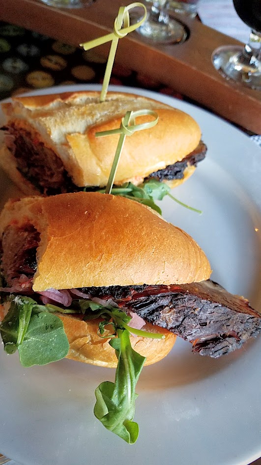 Example Food at Saraveza Smoked Brisket Sandwich with pimento cheese, red onion pickle, and arugula