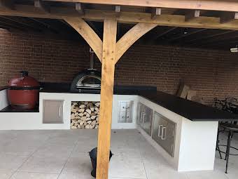 An oak frame construction outdoor kitchen with pizza oven , barbecue and seating area  album cover