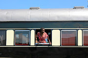  Kenyan passenger Lois Eva Adongo peeks out at a pit stop. 