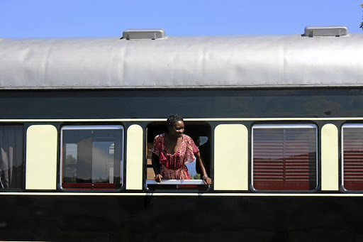 Kenyan passenger Lois Eva Adongo peeks out at a pit stop.