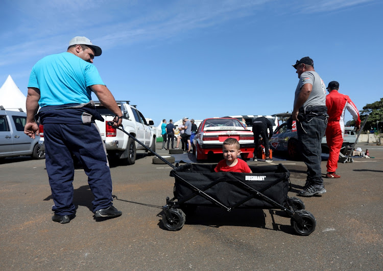 Tiaan Francis, 31, plays with his son, Lihan, 2, before competing during the Red Bull Car Drift at Suncoast in Durban.