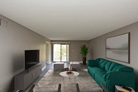 View of staged living room with decor, grey walls, sliding glass door