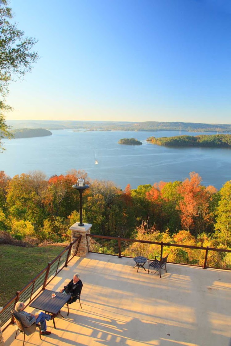 Guests on a lodge patio with a view of Guntersville Reservoir and Lake Guntersville Resort State Park in Guntersville, Ala.