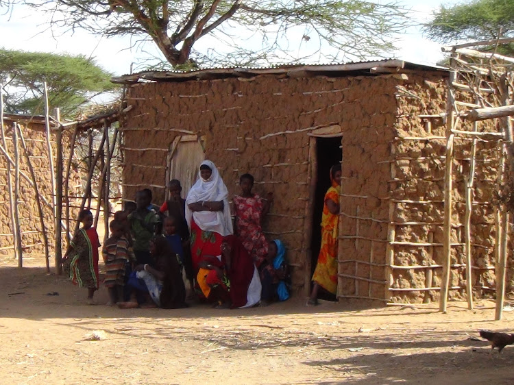 Family members outside their shanty at the illegal Enyali settlement inside the South Kitui National Reserve. The Enyali illegal settlement was flattened during the ongoing security operation.