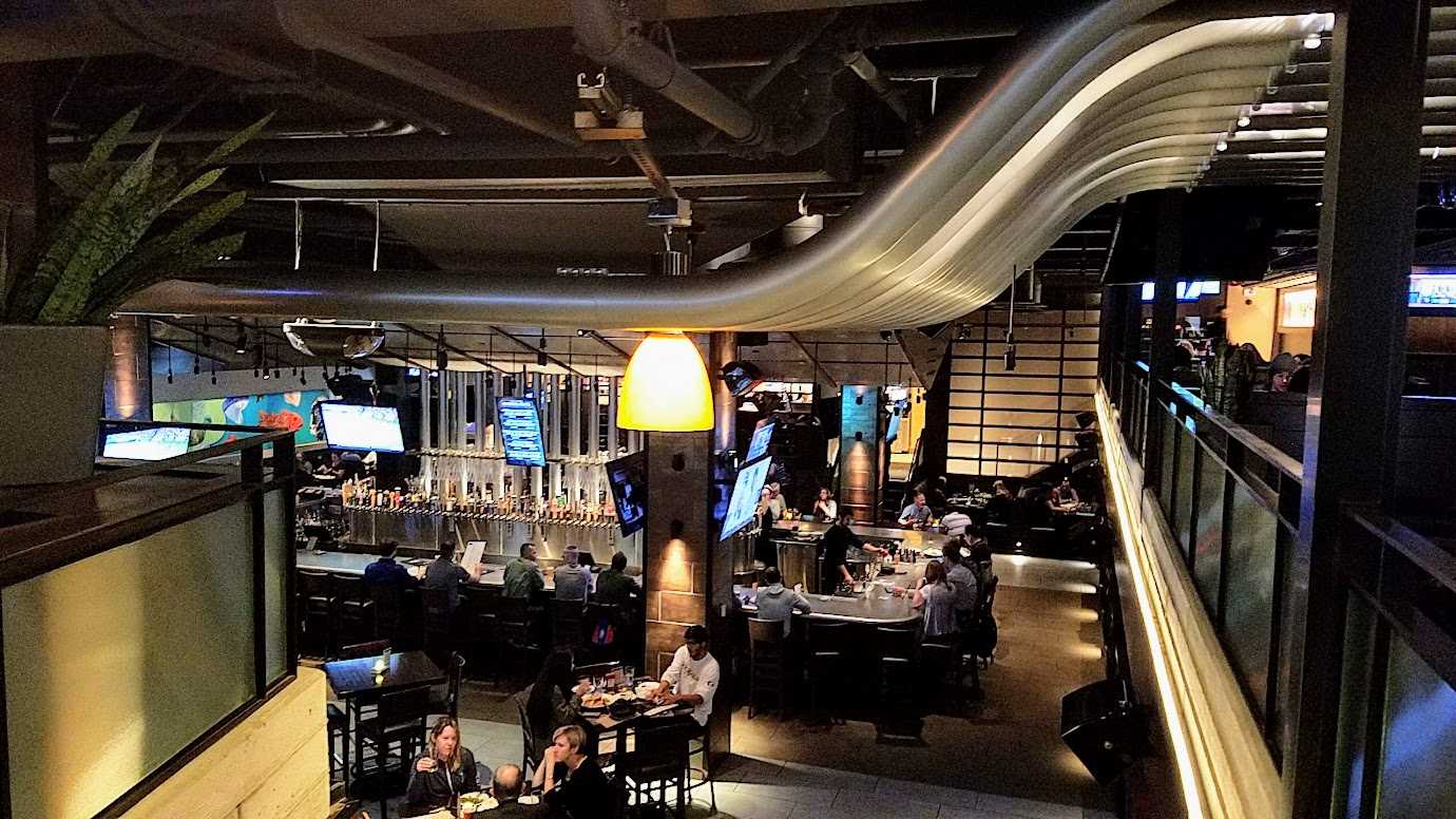 Yard House Portland offers 130 taps with a keg room holding over 5000 gallons of beer. When you are dining in the downstairs area, just look up: those metal cylinders carry six lines each, from the refrigerated keg room to the tap