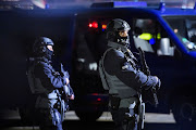 Officers of German BFE police unit are standing on the apron of Hamburg Airport on November 4, 2023 in Hamburg, Germany.  