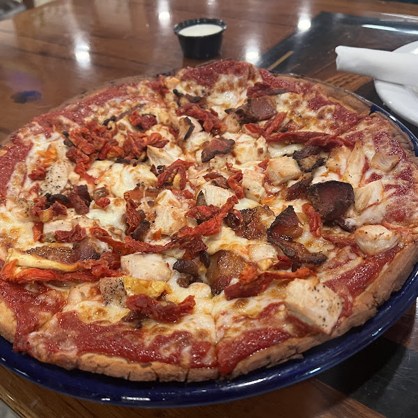 Italian herb gluten free pizza crust with chicken, jalapeño bacon, and sun dried tomatoes