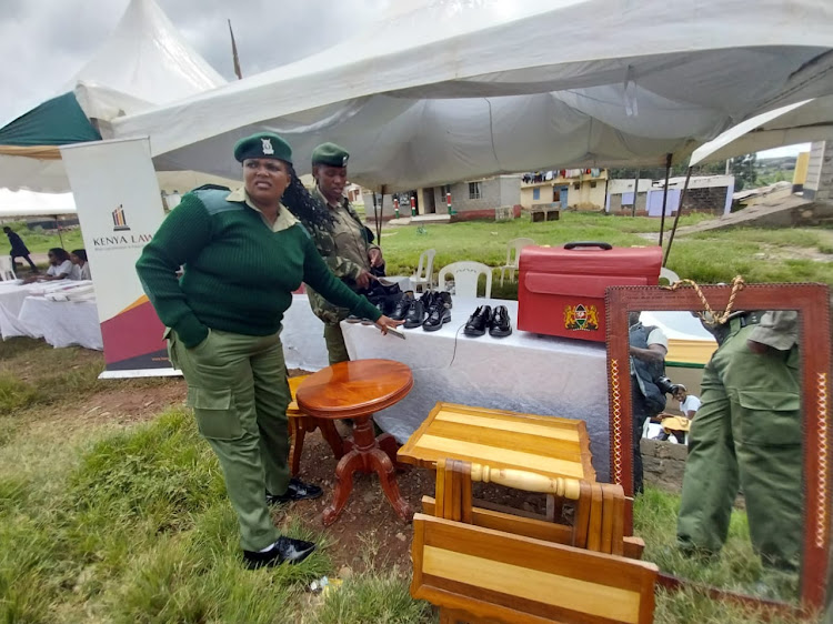 Officers from the Athi River GK Prison, Kitengela display inmates' merchandise during the Mavoko Law Courts Open Day in Mlolongo, Machakos County on April 26, 2024.