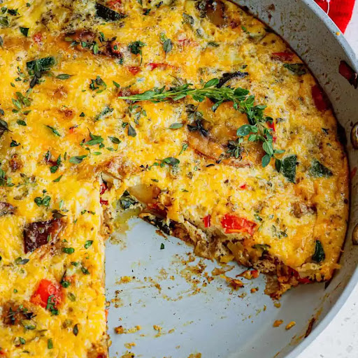 A quick and tasty, easy Egg Frittata made with potatoes, onions, zucchini, mushrooms, red bell pepper, cheddar, and Parmesan Cheese.   Cook up a tasty one today and enjoy all the health benefits of eggs, vegetables, and cheese. 
