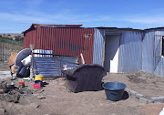 The shack in Ntsako Village which is home for a 17-year-old pupil. The fire is where meals are prepared and the chair is where breakfast was eaten. 