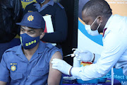 Tebogo Rafapa, 30, of Diepsloot police station gating his jab during the launch of vaccination roll out programme in Orlando Stadium, Soweto. Some members didn't receive their jabs in Durban on Thursday as scheduled. 