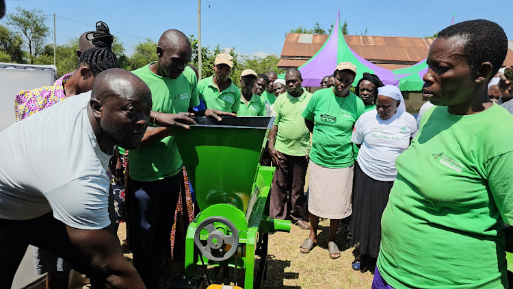 A man demonstrates how to use some of the machines that were donated by International Centre for Agriculture Research in Dry Areas.