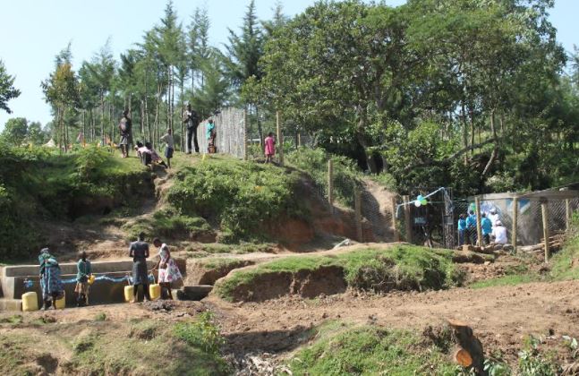 Residents of Gorgor fetch water at the newly-contructed spring water project after its unveiling by Dig Deep (Africa) in celebrations to mark World Water Day in Bomet County on Tuesday March 22, 2022.