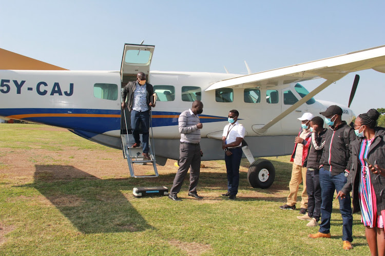 Passengers alight from Mombasa Air Safari plane at Kabunde airstrip in Homa Bay town on June 11,2021