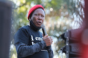 EFF leader Julius Malema outside the US embassy in Pretoria on Monday. Malema challenged black people to date white people to forge integration between races and 'to infiltrate their wealth and land.