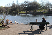 A resident sits at Zoo Lake, 29 June 2021, in Johannesburg. 