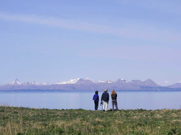 Travelers take in the expansive landscape on Kodiak Island off the southern coast of Alaska. 