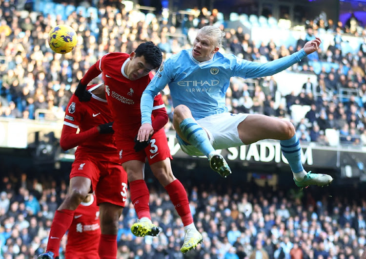 Manchester City's Erling Haaland (right) in action with Liverpool's Wataru Endo.