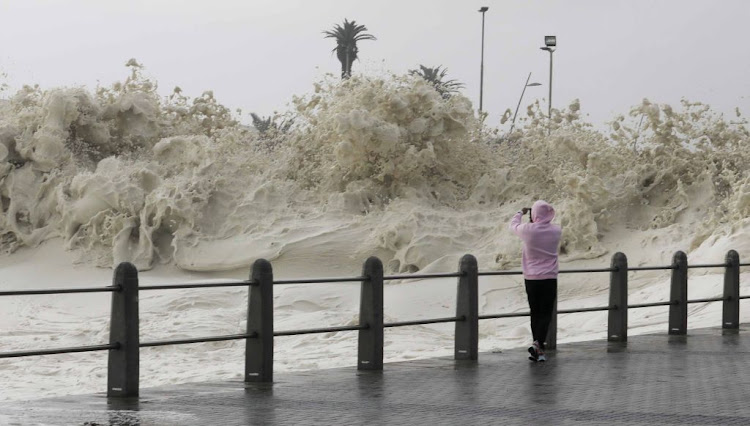 The cold front brought gale force winds, rough seas and sea foam, which happens when large blooms of algae decay offshore and are agitated by wind and waves, to the shores of Sea Point promenade in Cape Town on July 13 2020.