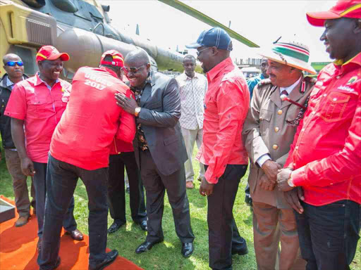 President Uhuru Kenyatta embraces Chama Cha Mashinani leader Isaac Rutto at the start of Jubilee's campaign rally at Kapkatet grounds in Kericho, September 8, 2017. /PSCU