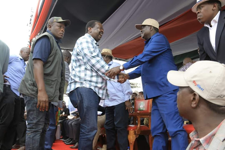 OANC leader Musalia Mudavadi is welcomed by DM leader Raila Odinga during the Western BBI meeting at Bukhungu Stadium on Saturday
