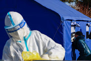 A woman is tested at a nucleic acid testing site following an outbreak of the coronavirus disease (COVID-19) in Beijing, China, January 18 2021. 
