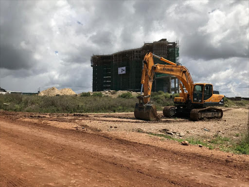 An excavator packed on a side road near an eight-storey building under construction at the Konza Technopolis site, December 5, 2018. /Thomson Reuters Foundation