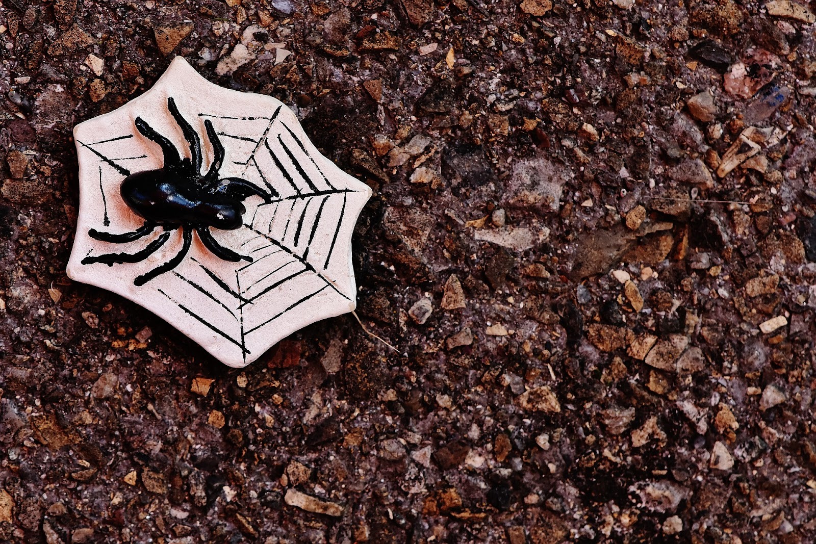 A spider Halloween decoration on the ground