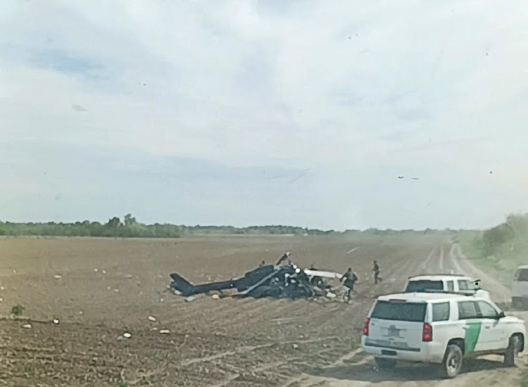 A view from inside a vehicle shows emergency services personnel responding to a helicopter crash near La Grulla, Texas, United States, March 8, 2024.