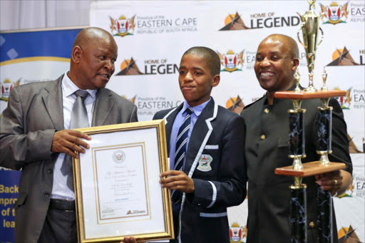 STAR IN THE EAST: Luvo Luzipho from St James Senior Secondary School in Cofimvaba was named number one pupil in the Eastern Cape at the top achievers gala dinner in East London on Tuesday evening. He is flanked by education MEC Mandla Makapula and Eastern Cape premier Phumulo Masualle Picture: STEPHANIE LLOYD