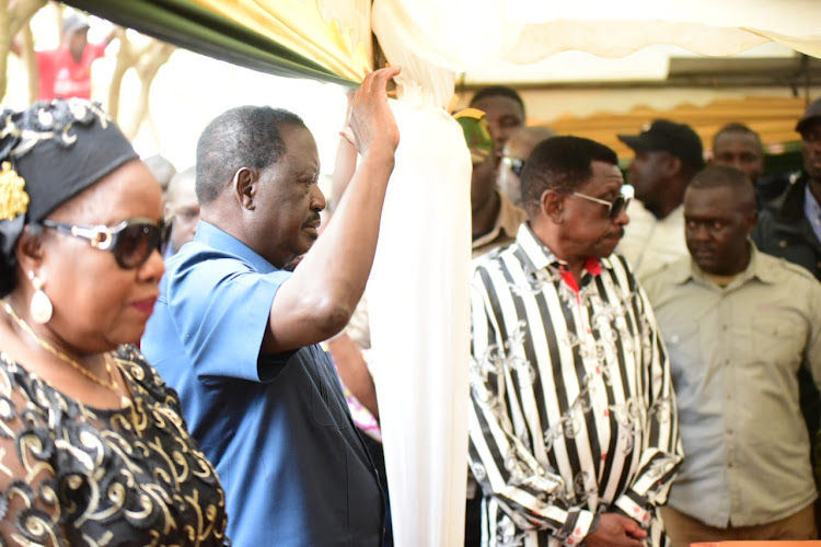 Opposition leader Raila Odinga salutes bodies of five people who died during the recent anti-government protests in the country on Friday at Jaramogi Oginga Odinga park in Bondo town. Image: JOSIAH ODANGA