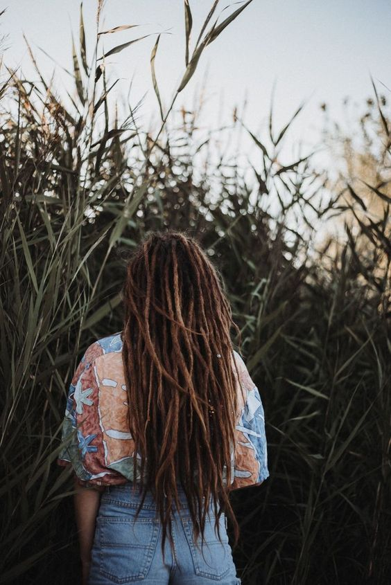 a lady's back view showing her human hair dreadlocks with extensions