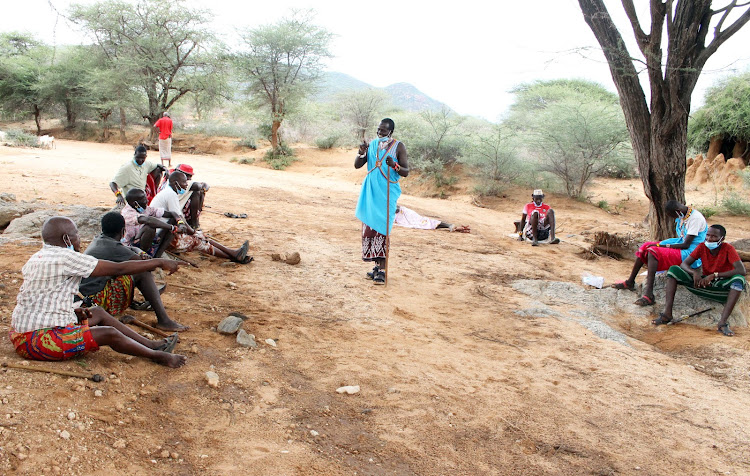 Francis Lemoile speaks to Samburu elders at Sasaab village, Westgate Conservancy, Samburu East, on May 10