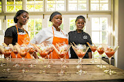 Why Cook staff members flank co-owner Yolanda Nomoyi.