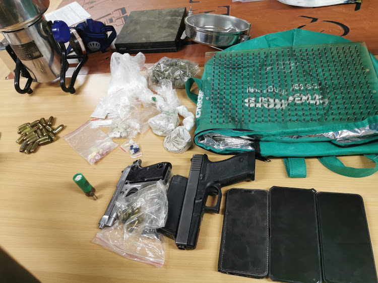 Heroine powder, industrial grinder with heroine residue, cocaine powder, crystal meth, ecstacy and mandrax tablets, approximately 1.6 million empty capsules, two firearms and several rounds of ammunition were found in the possession of the suspects.
