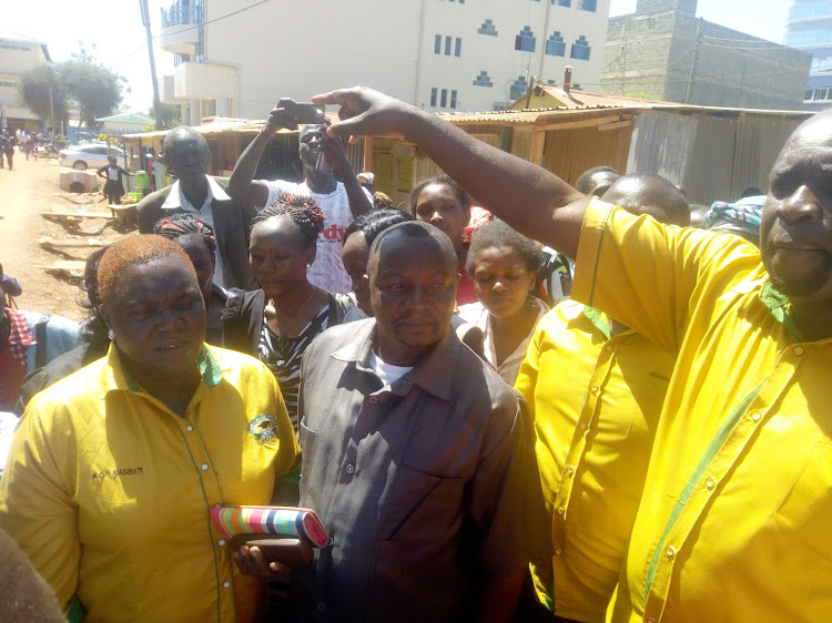 Teachers celebrate with Chrispinus Wanyonyi in suit when he was aquited by a Bungoma court