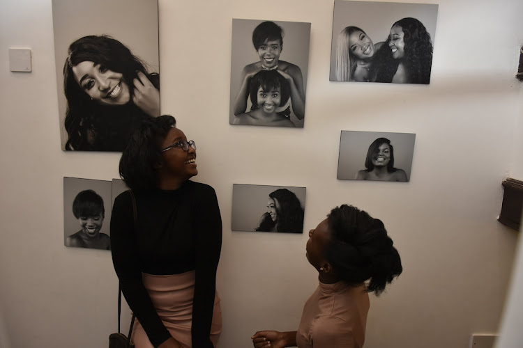 Betty Kyalo's sister Gloria Kyallo and her friend Caren Kibbett admire the portraits at the parlour