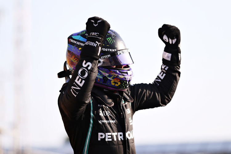 Fastest qualifier Lewis Hamilton celebrates in parc ferme during qualifying ahead of the F1 Grand Prix of Great Britain at Silverstone on July 16, 2021 in Northampton, England.