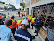 City Power managers, engineers and technicians gather above the tunnel on Ntemi Piliso and Anderson streets. The underground tunnels tripped two main lines to Central and Selby substation.