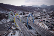 Five Olympic rings arch over a highway leading to venues for the Winter Olympics Beijing 2022 in Zhangjiakou, Hebei province, China