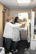 HELPING HAND: An oncologist does some tests on a patient.